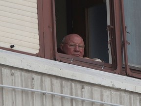 In this July 28, 2014, photo, Jakob Denzinger looks from his apartment window in Osijek, eastern Croatia.  (AP Photo/Darko Bandic)