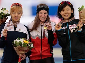 Medallists, from left, Kim Bo-Reum, of Korea, Ivanie Blondin, of Canada, and Takagi Miho, of Japan, show off their silver, gold and bronze medals after the mass start race of the speedskating single distance World Championships in Kolomna, Russia, on Sunday, Feb. 14, 2016. (AP Photo/Ivan Sekretarev)