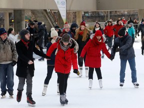 People skating Sunday at Nathan Phillips Square. (MICHAEL PEAKE, Toronto Sun)