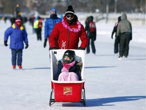 Steve Henry pushes his daughter, Julia, in a sled during the CIBC Skate for the Cure on the Rideau Canal Skateway on Sunday, Feb. 14, 2016. DARREN BROWN / POSTMEDIA