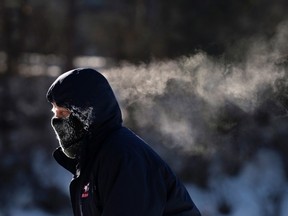 A skater's breath trails behind him as he skates on the Rideau Canal Skateway in Ottawa on Sunday, Feb. 14, 2016 as an extreme cold warning is in affect, with morning temperatures at -28C, feeling like -38C with the wind chill. THE CANADIAN PRESS/Justin Tang