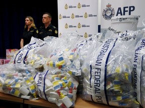 A quantity of liquid methamphetamine disguised in various packaging is put on display by Australian Border Force officers at the Australian Federal Police headquarters in Sydney, February 15, 2016. Australian authorities said on Monday they had seized A$1.25 billion ($890.5 million) worth of liquid methamphetamine, or "ice", their largest haul of illicit drugs in two years.    REUTERS/Jason Reed