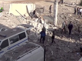 People gather near what is said to be a hospital damaged by missile attacks in Azaz, Aleppo, Syria, Feb. 15, 2016 in this still image taken from a video on a social media website. REUTERS/Social Media Website via Reuters