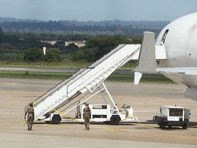 Zimbabwean Armed Soldiers patrol around a United States registered cargo plane at Harare International Airport in Harare, Zimbabwe, Monday, Feb.15, 2016.  (AP Photo/Tsvangirayi Mukwazhi)