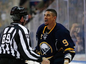 Buffalo Sabres left wing Evander Kane (9) is held back by linesman Steve Miller (89) after fighting Florida Panthers defenseman Alex Petrovic (not shown) for the second time during the second period at First Niagara Center. Kevin Hoffman-USA TODAY Sports