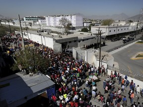 Family members of inmates gather outside the Topo Chico prison in Monterrey, Mexico, February 11, 2016. Fifty-two people were killed and twelve people were wounded in a prison riot in Monterrey in the northeastern Mexican state of Nuevo Leon, governor Jaime Rodriguez said in a news conference on Thursday. (REUTERS/Daniel Becerril)