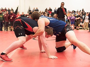 Bayside's Mike Parsons (left) battles Quinte opponent Randy Brant in a heavyweight semi-final bout at last week's Bay of Quinte wrestling championships at BSS. Brant went on to win a gold medal in the division. (Isaac Paul for The Intelligencer)