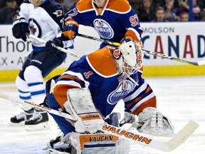 Winnipeg Jets' Nikolaj Ehlers (27) is stopped by Edmonton Oilers goalie Laurent Brossoit (1) as Connor McDavid (97) defends during first period NHL action on Saturday, Feb. 13 at Rexall Place.