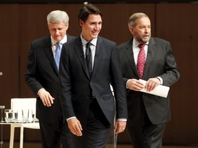 Liberal leader Justin Trudeau (C), Conservative leader and Prime Minister Stephen Harper (L), and New Democratic Party (NDP) leader Thomas Mulcair (R), walk off stage at the end of the Munk leaders' debate on Canada's foreign policy in Toronto, Canada September 28, 2015. Canadians go to the polls in a federal election on October 19, 2015. REUTERS/Fred Thornhill