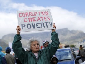 Demonstrators carry placards as they march to protest against corruption in Cape Town, September 30, 2015.  REUTERS/Mike Hutchings/Files
