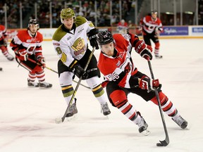 Trent Mallette of the 67's (R) drives to the net against Steve Harland of the North Bay Battalion on Feb. 15. (Wayne Cuddington, Postmedia Network).