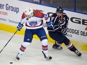 Edmonton Oil Kings defenceman Ben Carroll keeps the puck away from Tri-City Americans forward Beau McCue in first period of their WHL contest Monday afternoon at Rexall Place. The Oil Kings gave up a short-handed goal in the third period, which proved to be the game winner in a 3-1 loss to the Americans.