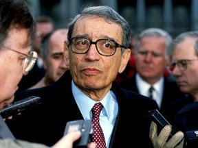 U.N. Secretary-General Boutros Boutros-Ghali is surrounded by members of the media as he leaves the White House after meeting U.S. President Bill Clinton, in this February 23, 1993 file picture. REUTERS/Stringer/Files