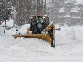 A city plow clears a portion of Clergy Street near Johnson Street during a heavy snowstorm last month. Environment Canada was predicting about 30 centimetres to fall in the area again this week. Ian MacAlpine/Whig-Standard file photo)