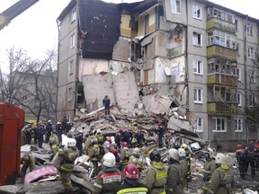 Russian Emergencies Ministry members work at the site of a residential five-storey apartment building after a gas explosion in the early morning, in the city of Yaroslavl, northeast of Moscow, Russia, February 16, 2016. (Press Service of Russian Emergencies Ministry in Yaroslavl region/Handout via Reuters)