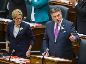 Minister of Finance Charles Sousa tables the 2015 Ontario Budget alongside Premier Kathleen Wynne at Queen's Park April 23, 2015. (Ernest Doroszuk/Toronto Sun)