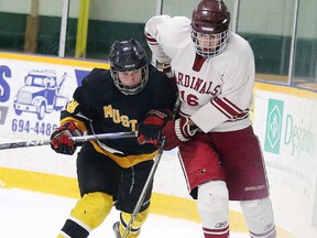 Manitoulin Mustangs Mason Pine and St. Charles Cardinals Bryceton Lalonde battle for the puck during boys division A high school hockey semi-final action in Sudbury, Ont. on Tuesday February 16, 2016.