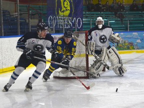Charlie Yelkin, right, of the Norfolk Vikings chases the puck around the net with Aaron Smith of the Halton Ravens while goaltender Mitchell Payne looks on during the second period of Thursday's Greater Metro Junior Hockey League hockey game at Talbot Gardens. Tillsonburg will join the GMHL for the 2016-17 season and return junior hockey to the city for the first time since 1991. (EDDIE CHAU/Simcoe Reformer)