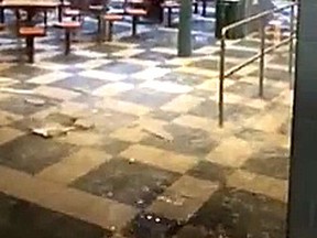 This image from a Facebook video shows water pouring into a Fanshawe College food court after a sprinkler pipe froze and burst Monday. (Special to The Free Press)