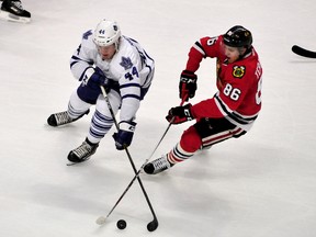 Maple Leafs defenceman Morgan Rielly (left) is defended by Blackhawks left wing Teuvo Teravainen (right) during second period NHL action in Chicago on Monday, Feb. 15, 2016. (David Banks/USA TODAY Sports)