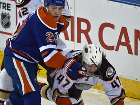 Leon Draisaitl takes down Ducks forward Hampus Lindholm in the fisrst period of Tuesday's game at Rexall Place. (Ed Kaiser)