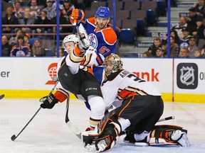Anaheim Ducks defencemen Hampus Lindholm is tripped up by Edmonton Oilers forward Benoit Pouliot in front of Ducks goaltender Frederik Andersen's creaseat Rexall Place on Tuesday. (Perry Nelson-USA TODAY Sports)