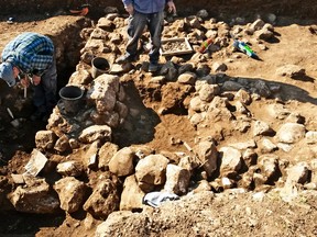 This handout photo released by the Israel Antiquities Authority on Wednesday, Feb. 15, 2016, shows work on uncovering of an ancient settlement in Jerusalem. Israeli archaeologists have discovered a 7,000-year-old settlement in northern Jerusalem in what they say is the oldest discovery of its kind in the area. ( Israel Antiquities Authority via AP)