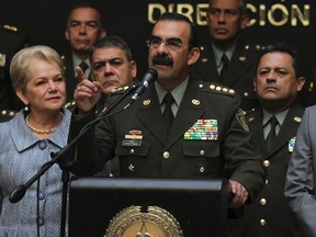 Colombia's General Rodolfo Palomino, the head of the national police, accompanied by his wife and his children, speaks during a news conference in Bogota, Colombia, February 17, 2016. REUTERS/John Vizcaino