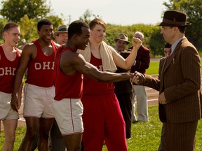 This photo provided by Focus Features shows Stephan James, center, as Jesse Owens, and Jason Sudeikis, right, as Larry Snyder, in Stephen Hopkins’ "Race," a Focus Features release. (Thibault Grabherr/Focus Features via AP)