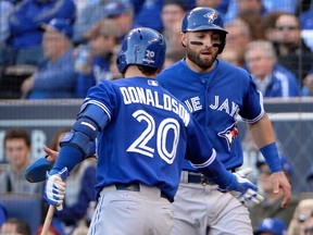 Toronto Blue Jays center fielder Kevin Pillar (11) celebrates with third baseman Josh Donaldson (20) after scoring a run during the third inning against the Kansas City Royals in game two of the ALCS at Kauffman Stadium. John Rieger-USA TODAY Sports
