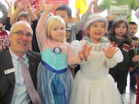 Jim Janzen, president and CEO of the YMCAs across southwestern Ontario, celebrates the launch of the 2016 Strong Kids Campaign with Mikayla Coubrough, 3, centre, and Alyssa Solinas, 4, from the child care centre at the Jerry McCaw Family Centre on Wednesday February 17, 2016 in Sarnia, Ont. This year's campaign goal is to raise $224,300 to help families in financial need attend programs at the YMCA in Sarnia.
(Paul Morden, The Observer)