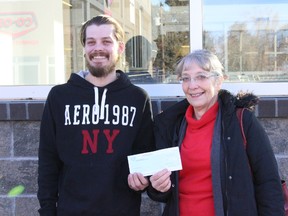 Justin Carriere, left, and Linda Jacejko, right, accept a cheque from Eastalta Co-op as part of its employee community involvement program. Carriere contributed at least 100 volunteer hours to the Habitat for Humanity build in Vermilion.