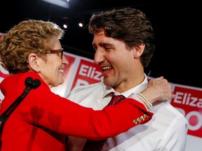 Premier Kathleen Wynne and Prime Minister Justin Trudeau embrace during a rally for the Liberal byelection candidate in Whitby-Oshawa February 9, 2016. (Dave Thomas/Toronto Sun)