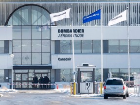 People enter a Bombardier plant, Wednesday, February 17, 2016 in Montreal. Bombardier announced Wednesday it will eliminate 7,000 positions over two years. THE CANADIAN PRESS/Paul Chiasson