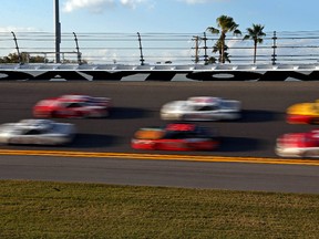 NASCAR Sprint Cup drivers speed through turn four during practice for the Daytona 500 Wednesday at Daytona International Speedway. (Peter Casey/USA TODAY Sports)