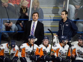 Flint Firedbirds coach John Gruden, back left, looks up at the scoreboard during the second period against the Sarnia Sting at Dort Federal Event Center in Flint, Mich., on Nov. 13, 2015. (Jake May/The Flint Journal-MLive.com via AP)