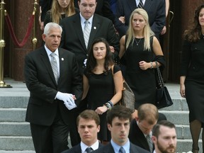 Surviving daughters Katerina Marie Savopoulos and Abigal Marie Savopoulos folllow behind the casket of their 10-year old brother Philip Savopoulos after a funeral service the Saint Sophia Greek Orthodox Cathedral June 1, 2015 in Washington, DC. (Mark Wilson/Getty Images/AFP)