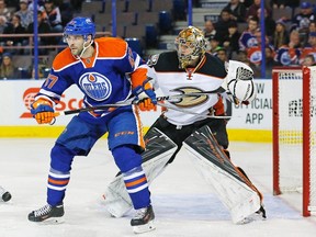 Edmonton Oilers forward Benoit Pouliot, left, tries to screen Anaheim Ducks goaltender Frederik Andersen on Tuesday. Pouliot took two penalties in the game and found himself in head coach Todd McLellan’s dog house.