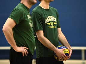 Brock Davidiuk, right, and Terry Danyluk watch the Bears volleyball team practice at the Saville Community Sports Centre on Wednesday. (Ed Kaiser)