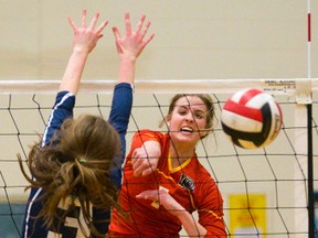 Saunders? Madeline Lethbridge blows a spike down the line past the block of Simone White during their TVRA Central AAA senior girls volleyball semifinal at Lucas on Wednesday. The Sabres avenged a loss on the same floor last week by beating the Vikings 3-1 and will face Oakridge on Friday for the conference championship. (MIKE HENSEN, The London Free Press)