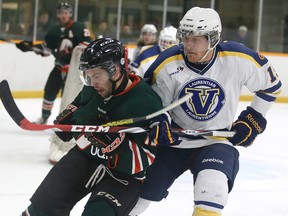 A Laurentian Voyageurs men's hockey team player (right) tangles with a UQTR Patriotes player during OUA playoff action at Gerry McCrory Countryside Sports Complex on Wednesday night.