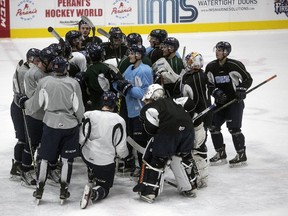 The Flint Firebirds gather up in a circle during the first day of practice on Wednesday, Nov. 11, 2015 after recommitting to the team following a brief all-team strike due the owner Rolf Nilsen's decision to fire the coaching staff. (Sean Proctor/The Flint Journal-MLive.com via AP)