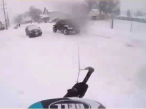 Video still of a snowboarder meeting an oncoming car while illegally riding on a Kingston street. Kingston Police handout.
