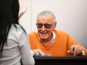 Comic book legend Stan Lee signs autographs at the Marvel booth during day two of the 2015 San Diego Comic-Con International, Friday, July 10, 2015, in San Diego. (Kevin Sullivan/The Orange County Register via AP)