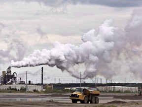A dump truck works near the Syncrude oil sands extraction facility near the city of Fort McMurray, Alta., on June 1, 2014. (THE CANADIAN PRESS/Jason Franson)