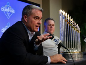 Kansas City Royals general manager Dayton Moore, left, and manager Ned Yost speak to the media with their World Series trophy Thursday, Nov. 5, 2015, in Kansas City, Mo. (AP Photo/Charlie Riedel)