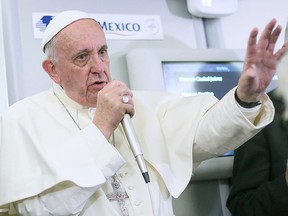 In this photo taken Wednesday, Feb. 17, 2016 Pope Francis meets journalists aboard the plane during the flight from Ciudad Juarez, Mexico to Rome, Italy.  (Alessandro Di Meo/Pool Photo via AP)