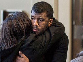 Lawyer Lyle Howe, centre, hugs supporters after sexual assault charges against him were formerly dropped at Supreme Court in Halifax on Thursday, Feb. 18, 2016. THE CANADIAN PRESS/Darren Calabrese