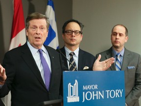 Mayor John Tory, left, Deputy Mayor Denzil Minnan-Wong and Councillor Stephen Holyday talk about the city budget and labour contract talks at City Hall on Thursday, February 18, 2016. (Veronica Henri/Toronto Sun)