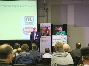 Ralph Dietrich, chair of Dairy Farmers of Ontario, answers questions at the end of the Southwestern Ontario Dairy Symposium. Jack Rodenburg, at right, also announced his intention to retire after twelve years running the conference. (MEGAN STACEY, Sentinel-Review)